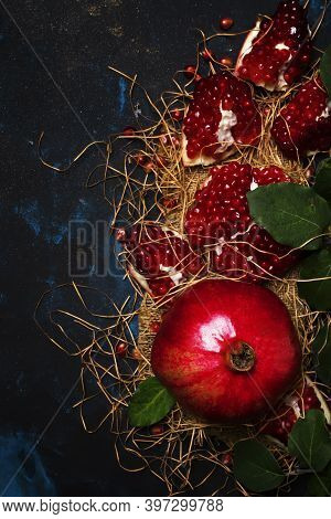 Red Pomegranate In The Starw, Rustic Style, Black Background, Top View