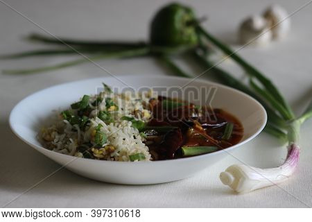 Egg Fried Rice And Chilli Garlic Chicken Gravy, Prepared In Indo-chinese Style