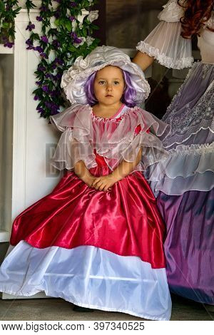 Beautiful Little Girl Dressed In A Luxurious Vintage Red Dress.puppet Museum, July 2020 In Preili, L
