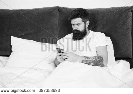 First Of All. Bearded Man Texting Sms In Bed. Hipster Send Message Using Smartphone. Mobile Message.