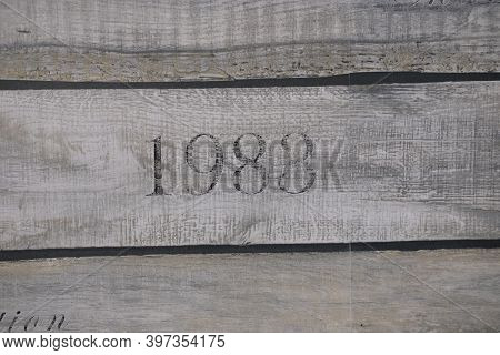 Wooden Texture Of Three Planks With Number 1983 Embrassed On It