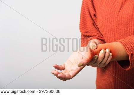 Close Up Hand Of Asian Woman She Holding Her Acute Pain In Wrist Of Hands, Studio Shot Isolated On W