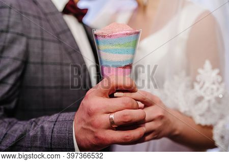 Wedding Ceremony, Mixing Sands Is A New Family. Close Up View Hands Of Bride And Groom Doing Sand Ce