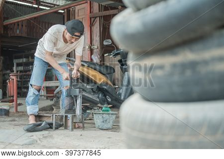 Tire Patcher Prepares A Traditional Press Before Patching The Inner Tube