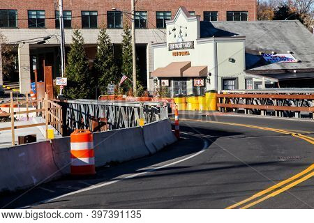 DARIEN,CT, USA-NOVEMBER 29 2020: Construction on bridge on Darien -Stamford border with  The Board Yard BBQ and Grill