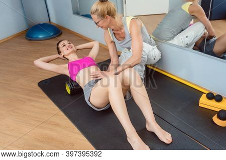 Woman doing Fascial training on the back during physical therapy