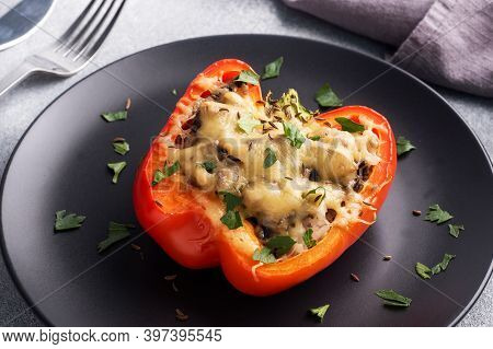 Stuffed Sweet Peppers With Rice Mushrooms And Cheese With Herbs. Baked Halves Of Red Pepper With Fil