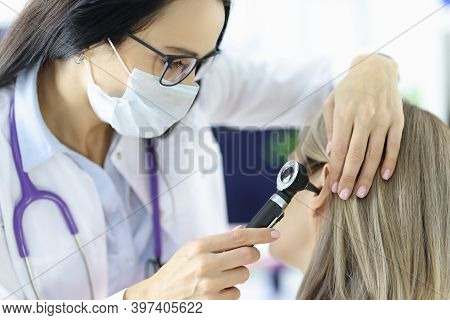 Otorhinolaryngologist Looking At Patients Ear With Otoscope In Clinic. Diagnosis And Treatment Of Ot