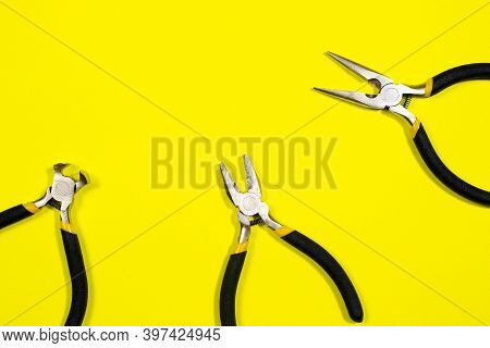 Tools On A Yellow Background With Space For Text. Pliers, Biters, Rounds, Tongs A Banner For A Const