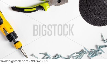 Building Tools Pliers, Self-cutters, Screwdrivers And Measuring Roulette On A White Background With 