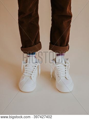 White sneakers with untied laces on man model