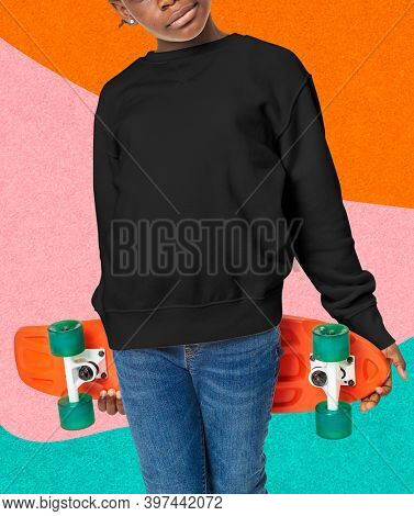 Young skateboarder in a black crewneck