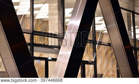 Combination Of Metal And Glass Wall Material. Steel Facade On Columns. Abstract Modern Architecture.