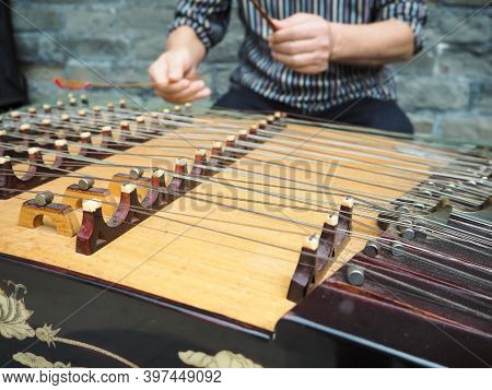 Old Man Playing With Bamboo Hammers On A Modern Yangqin With Five Courses Of Bridges, Beijing, China