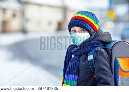 School Kid Boy With Glasses Wearing Medical Mask On The Way To School. Child Backpack Satchel. Schoo