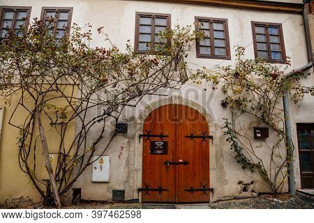Narrow Picturesque Street With Colorful Buildings In Old Historic Center, Vintage Oval Wooden Doors 