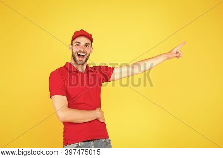 Delivery Concept. Portrait Of Smiling Deliveryman. Shows Away. Mail Service, Job And People Concept.