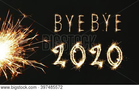 Bye Bye 2020. Bright Text And Sparkler On Black Background