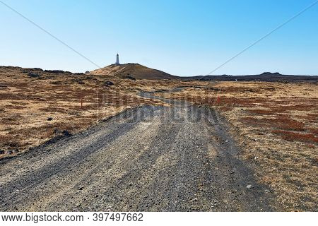 Gravel road in Iceland leading to a lighthouse on Reykjanes peninsula