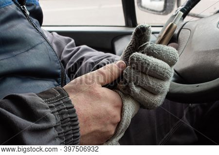 In The Hands Of The Driver In Gloves Cigarette Aikos