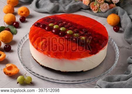 Red Jelly Cake With Berries And Sour Cream On Gray Background. Closeup. Horizontal Format