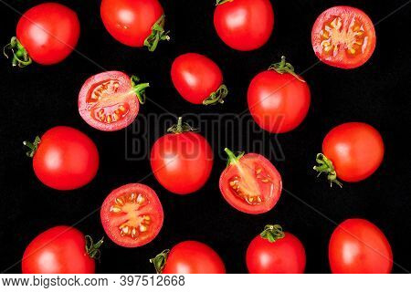 Fresh Cherry Tomatoes Isolated On A Black Background Whole And Cut In Half. Top View, Layout