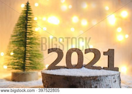 Numbers 2021 On Wooden Stand Against Festive Blurred Background With Bokeh. New Years Holiday Backgr