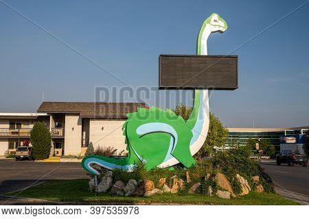 Vernal, Utah - September 20, 2020: Kitschy Green Roadside Dinosaur With A Blank Sign In The Downtown