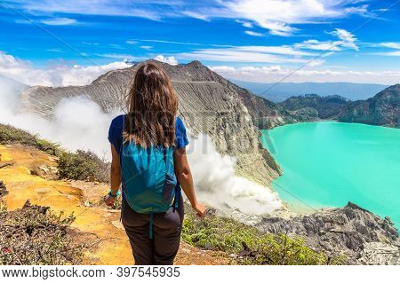 Woman Traveler At Crater Of Active Volcano Ijen, Java Island, Indonesia