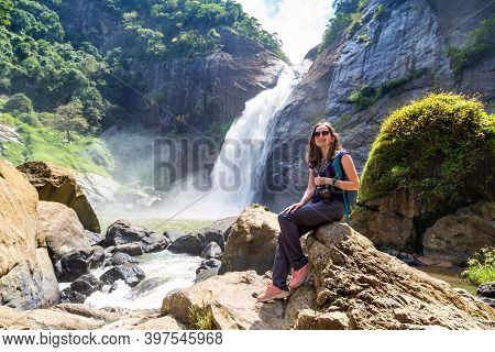 Woman Tourist And Dunhinda Waterfall In A Sunny Day In Sri Lanka