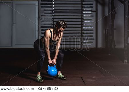 Young Sweaty Strong Muscular Fit Girl Holding Heavy Kettlebell With Her Hands Preparing For Swing Ha