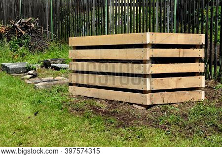 A Composter Made Of Natural Beech Prisms Built Horizontally With Black Foil Inside In A Meadow Near 