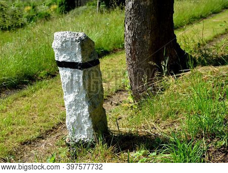 Mountain Road With Traditional White Stone Bollards With A Black Stripe. Old Stone Pillars Of Granit