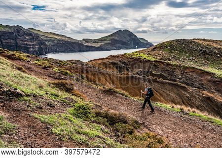 Girl Hiking Rocky Cliffs Clear Near Water Of Atlantic Ocean Bay Ponta De Sao Lourenco, The Island Of