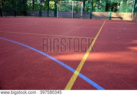 Public Multifunctional City Playground With Tartan Surface In The Park Is Used To Play Basketball Fo