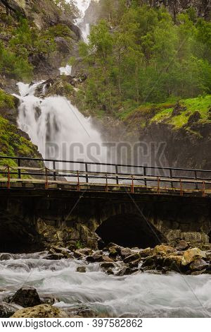 Norwegian Landscape. Waterfall Latefoss Latefossen With Stone Arched Bridge Road, Odda Hordaland Nor