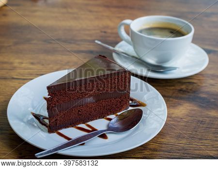 Delicious Chocolate Cake With Spoon On White Plate