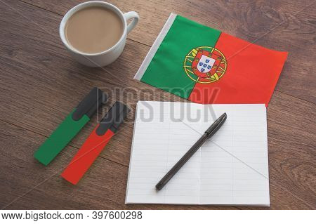 Portuguese National Flag, Pen, Notebook, Markers And Coffee Cup On Wooden Table, Foreign Language Le