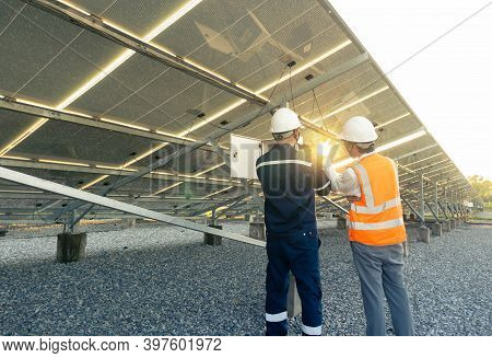 Technician With Engineer Are Check The Performance Of The Solar Panels In The Solar Plant, Alternati