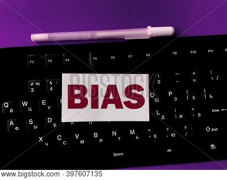 The Word  Bias Is Written On A White Piece Of Paper That Is On The Keyboard. The Concept Of Bias Bia