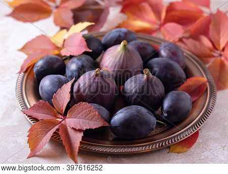 Ripe Plums And Figs On A Platter. Beautiful Food Photo. Picture. Cutting Board.