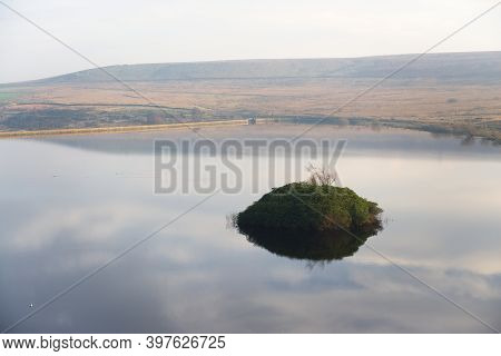 Reflected Sky In Calm Reservoir Water, Moors In The Sunny Background. Reservoir Wall Runs Along The 