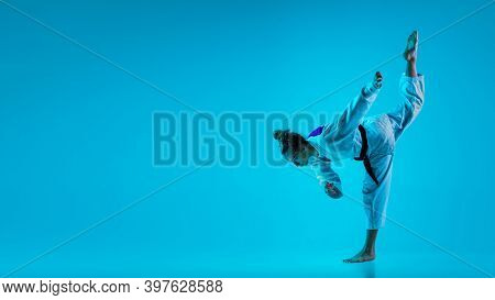 Concentration. Professional Female Judoist In White Judo Kimono Practicing And Training Isolated On 