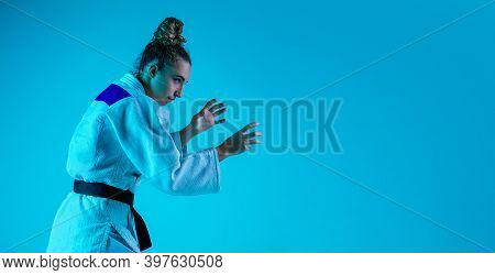View From Side. Professional Female Judoist In White Judo Kimono Practicing And Training Isolated On
