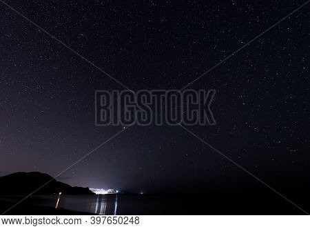 Starry Sky Over The Mountains At Night In Summer.