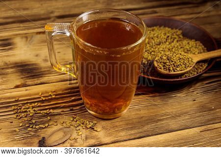 Egyptian Yellow Tea Or Methi Dana Drink And Fenugreek Seeds On Wooden Table