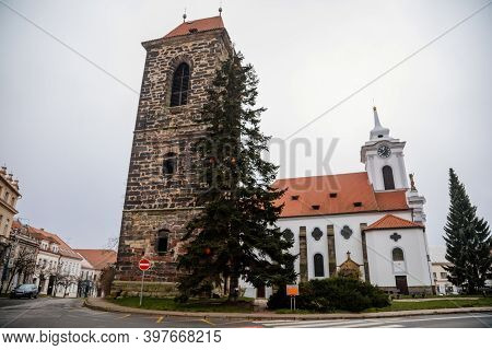 Gothic Medieval Stone Bell Tower And Baroque Saint Gothard Church In Old Historic Center Of Cesky Br