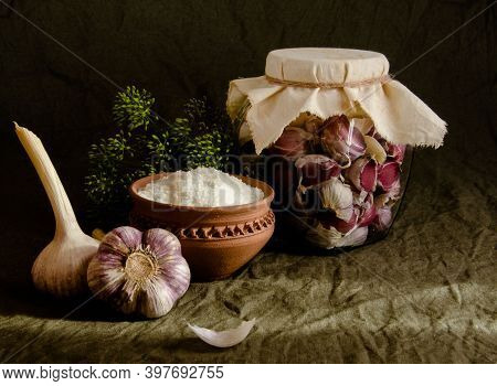 Rustic Still Life. Fresh Garlic On  Table In Heads And In  Glass Jar. Burning Healthy Vegetable. Whi