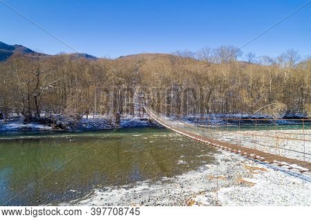 Beautiful Landscape With Mountain River And Suspention Bridge