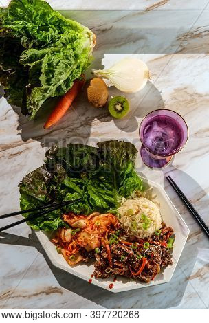 Korean Beef Bulgogi Ssambap Lettuce Wraps With Spicy Kimchi And Gochujang Hot Sauce